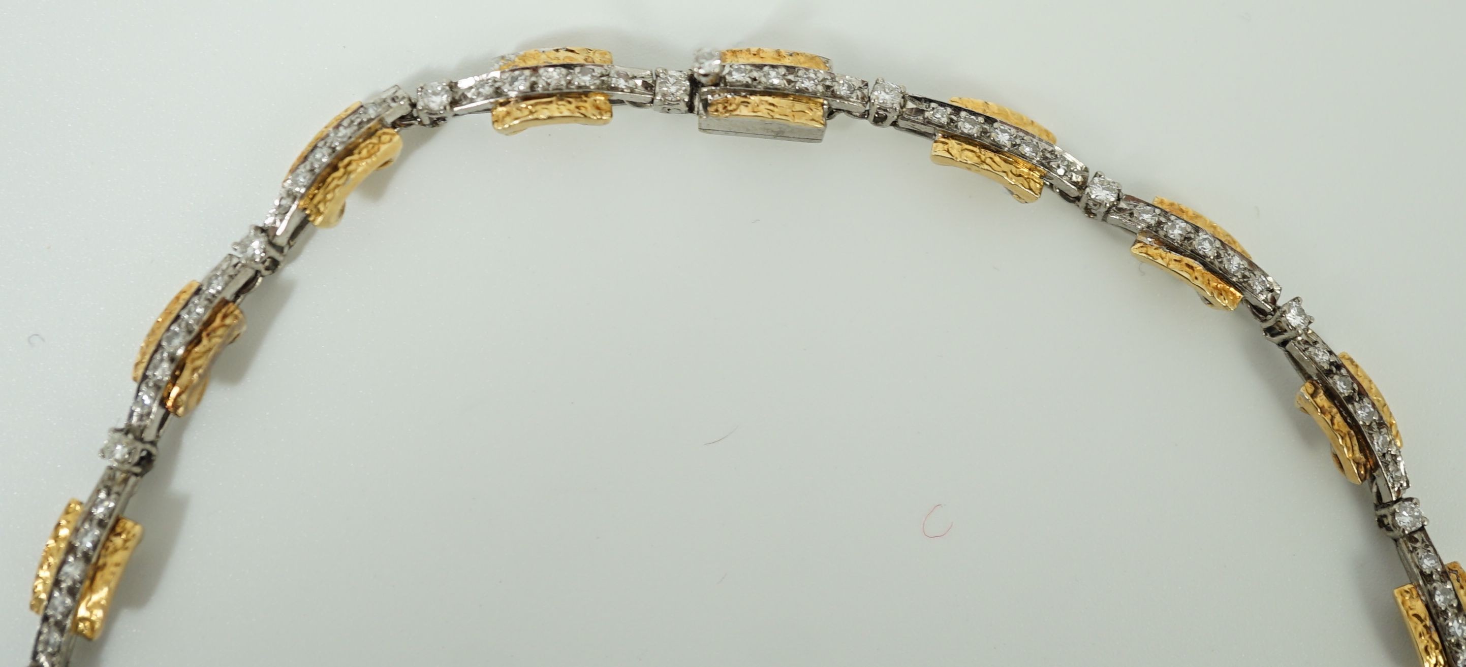 A 20th century two colour gold and diamond set necklace